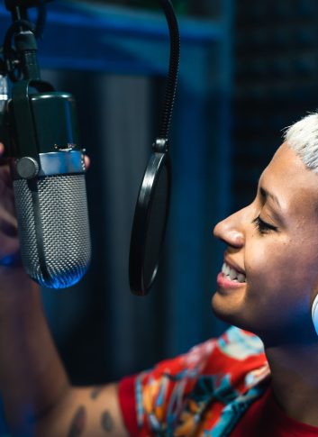 Young professional female singer recording a new song album inside music production studio